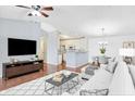 Bright, open living room with hardwood floors, modern furnishings, and a seamless flow to the kitchen at 17223 Gunther Blvd # 310, Westfield, IN 46074