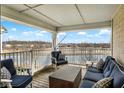 Relaxing covered patio with comfortable seating and scenic pond views at 17223 Gunther Blvd # 310, Westfield, IN 46074