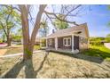Stylish home featuring a covered porch, gray siding, white trim, and a beautifully landscaped yard at 227 W 7Th St, Lapel, IN 46051