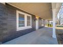 Cozy front porch with ample natural light, modern columns and a view of the yard at 227 W 7Th St, Lapel, IN 46051