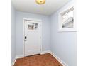 Bright foyer with a white door, tile flooring, and a window, creating a clean and welcoming entry space at 2914 N Delaware N St, Indianapolis, IN 46205