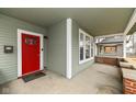 Covered front porch featuring a red door and a view of the home's facade, offering a welcoming entrance at 2914 N Delaware N St, Indianapolis, IN 46205