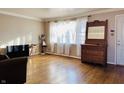 Sunlit living room with wood floors, traditional trim and space for decor at 3186 S Avon Ave, Plainfield, IN 46168