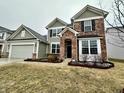 Charming two-story home with brick and siding, featuring a well-maintained front yard and attached garage at 4114 Spirea Dr, Plainfield, IN 46168
