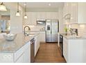 Modern kitchen featuring white cabinets, stainless steel appliances, and a granite countertop island at 517 Kentucky St, Fortville, IN 46040