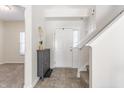 Bright foyer featuring clean lines, neutral colors, tiled floor and staircase leading upstairs at 5303 Brandywine Dr, Whitestown, IN 46075