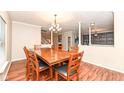 The formal dining room features a large wooden table and chair set and hardwood floors at 5815 Noble Dr, Indianapolis, IN 46234