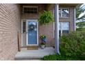 Inviting front entrance featuring a blue door with wreath, brick facade, and potted plants creating a welcoming atmosphere at 6006 Regency Dr, Columbus, IN 47203