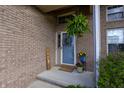 Inviting front entrance featuring a blue door with wreath, brick facade, and potted plants creating a welcoming atmosphere at 6006 Regency Dr, Columbus, IN 47203