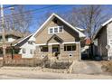 Charming two-story home with a covered front porch and a private driveway, nestled in a quiet neighborhood at 764 E 42Nd St, Indianapolis, IN 46205