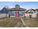 Back of home features two red doors, a yard and access to alley at 832 N Parker Ave, Indianapolis, IN 46201