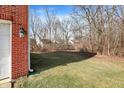 A view of the backyard with grass and woods at 9352 Tanhurst Dr, Indianapolis, IN 46250