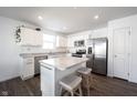 Modern kitchen boasts stainless steel appliances, white cabinetry, an island and an abundance of natural light at 9858 Oakmont E Dr, Pendleton, IN 46064