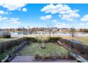 Backyard view with a statue, an arbor, and a manicured brick border around the garden at 9970 Southwind Dr, Indianapolis, IN 46256