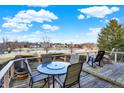 Outdoor deck features a table, chairs, a lake view, and a comfortable rocking chair at 9970 Southwind Dr, Indianapolis, IN 46256
