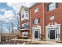 Elegant brick townhome showcasing architectural details and well-maintained grounds at 1072 3Rd Nw Ave, Carmel, IN 46032