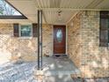 Inviting front porch with a decorative wood door and brick accents at 1202 E Stop 10 Rd, Indianapolis, IN 46227