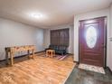 Spacious living area with hardwood floors, game table, and comfortable seating at 1202 E Stop 10 Rd, Indianapolis, IN 46227