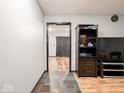 Open living room featuring a unique tile entryway and hardwood floors at 1202 E Stop 10 Rd, Indianapolis, IN 46227