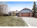 Attractive single-story home with brick and siding, a two-car garage, and landscaping in a suburban setting at 12205 Whitebark Dr, Indianapolis, IN 46236