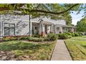 Well-maintained two-story home with tidy landscaping and inviting covered porch at 1322 N Alabama St # E, Indianapolis, IN 46202