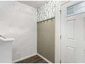Entryway with coat hooks, accent wallpaper, and white trim, creating a tidy and stylish space at 13858 N Zenas Ct, Camby, IN 46113