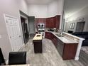 A kitchen with stainless steel appliances, granite countertops, tile flooring, and a center island at 2114 Cassia Dr, Plainfield, IN 46168