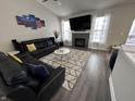 Bright living room features a fireplace, large windows with curtains, and a cozy sectional sofa at 2114 Cassia Dr, Plainfield, IN 46168