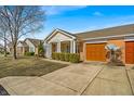 Inviting single-story home with an attached garage, tidy landscaping, and a concrete driveway at 2215 Elm Leaf Ln, Indianapolis, IN 46229