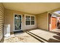 Covered front porch featuring a decorative glass door, a window, and a neutral color scheme at 2215 Elm Leaf Ln, Indianapolis, IN 46229