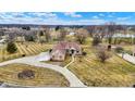 Expansive aerial view of estate home with a huge yard, mature trees, and a long driveway on a green space at 2566 E Fairway Village Dr, Greenfield, IN 46140