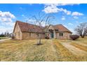 Charming single-Gathering home featuring a brick exterior, well-manicured lawn, and inviting entrance at 2566 E Fairway Village Dr, Greenfield, IN 46140