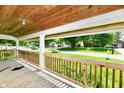 Inviting covered front porch with wood railing, offering a relaxing outdoor space with neighborhood views at 2850 Tansel Rd, Indianapolis, IN 46234