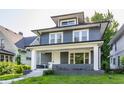 Charming home featuring new siding, complemented by a welcoming front porch and landscaped yard at 3543 N Kenwood Ave, Indianapolis, IN 46208