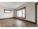 Bright living room featuring new floors, neutral paint, and large windows providing ample natural light at 3543 N Kenwood Ave, Indianapolis, IN 46208