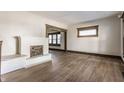 Inviting living room with a decorative fireplace, neutral paint, and beautiful hardwood floors at 3543 N Kenwood Ave, Indianapolis, IN 46208