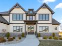 Captivating Tudor-style home with stone accents and a charming entrance adorned with wreaths, inviting visitors with its curb appeal at 3966 Chapel Hl Ct, Bargersville, IN 46106