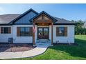 Inviting home entrance showcasing a wooden beam structure, double doors, and a walkway at 413 Cardinal Dr, Jamestown, IN 46147