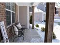 Cozy front porch with comfortable seating and rustic wooden columns at 5397 John Quincy Adams Ct, Plainfield, IN 46168