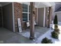 Inviting front porch seating area on a brick home with welcoming decor at 5397 John Quincy Adams Ct, Plainfield, IN 46168