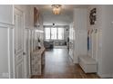 Inviting hallway with hardwood floors, stylish lighting, and decorative art at 5397 John Quincy Adams Ct, Plainfield, IN 46168