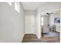 Bright foyer with white front door, modern light gray walls, and a view into the adjacent living room at 5461 Oak Knoll Dr, Whitestown, IN 46075