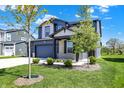 Charming two-story home showcasing a well-manicured lawn and tasteful landscaping at 5461 Oak Knoll Dr, Whitestown, IN 46075
