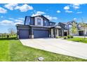Attractive two-story home featuring a two car garage, a well-manicured lawn, and a long driveway at 5461 Oak Knoll Dr, Whitestown, IN 46075