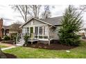 Attractive home with meticulous landscaping and a welcoming front porch perfect for enjoying the outdoors at 5626 Winthrop Ave, Indianapolis, IN 46220