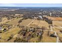 Expansive aerial view of the property, highlighting its location amidst fields, trees, and distant homes at 6724 E Spring Lake Rd, Mooresville, IN 46158