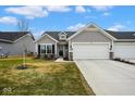 Charming single-story home with gray siding, a two-car garage, and a well-manicured front yard at 7091 Lillian Pl, Cumberland, IN 46229