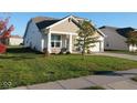 Well-manicured lawn enhances the curb appeal of this home with a two-car garage at 8105 Milender Blvd, Indianapolis, IN 46237