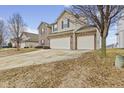 Charming two-story home featuring brick accents, a two-car garage, and a spacious front yard at 8547 S Tibbs Ave, Indianapolis, IN 46217