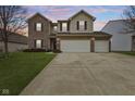 Inviting two-story home with brick and siding, a well-manicured lawn, and a convenient two-car garage at 8547 S Tibbs Ave, Indianapolis, IN 46217